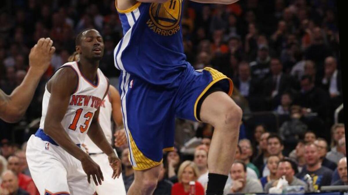 Golden State guard Klay Thompson (11) goes up for two points with New York guard Jerian Grant (13) trailing in the first half against the New York Knicks at Madison Square Garden in New York, Sunday, Jan. 31, 2016.