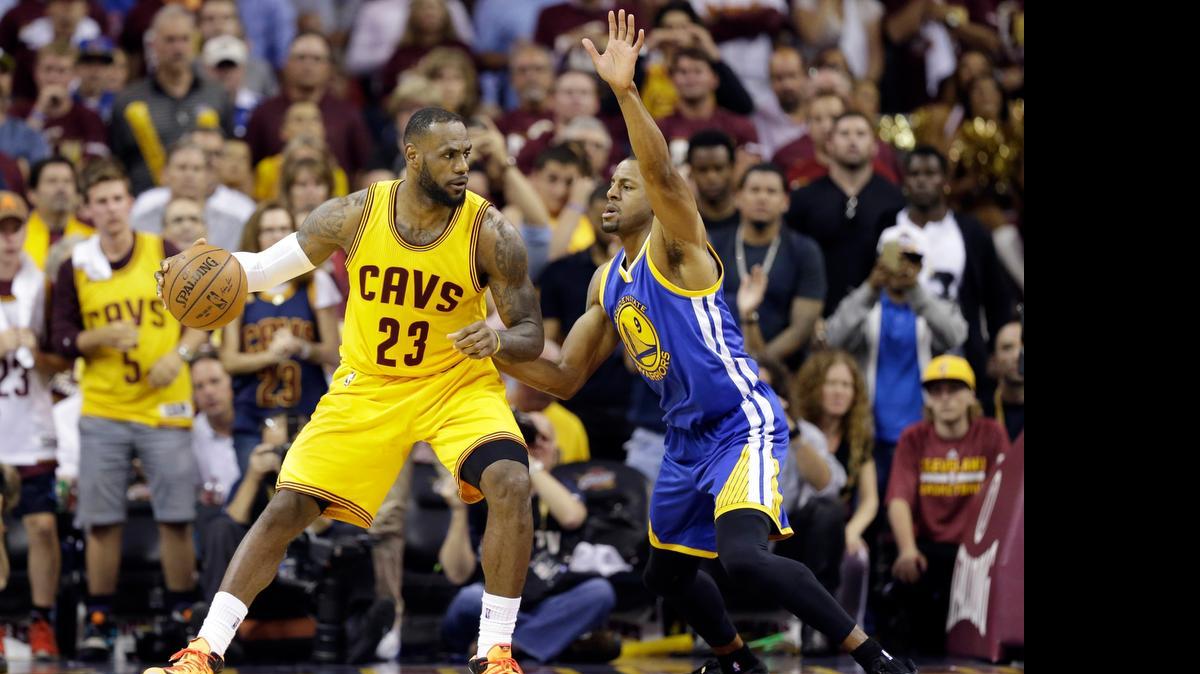 
Cleveland Cavaliers forward LeBron James (23) drives on Golden State Warriors forward Andre Iguodala (9) during the second half of Game 3 of basketball's NBA Finals in Cleveland, Tuesday, June 9, 2015. 

