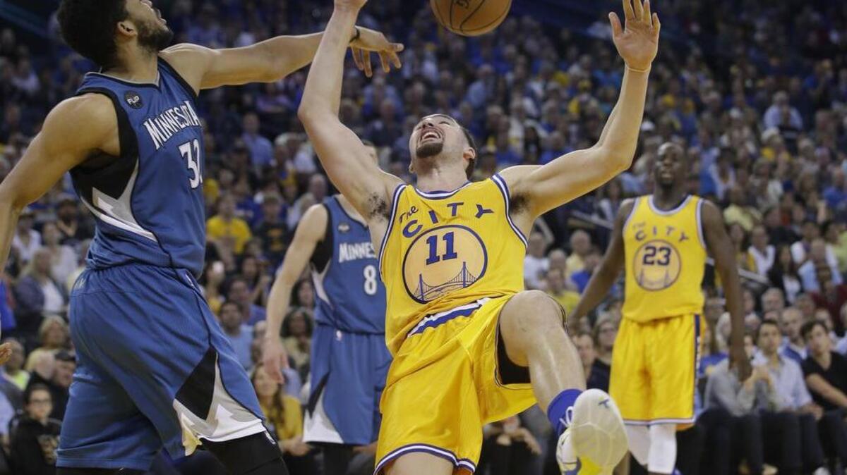 The Golden State Warriors’ Klay Thompson (11) has his shot blocked by the Minnesota Timberwolves’ Karl-Anthony Towns (32) during an NBA basketball game Tuesday, April 5, 2016, in Oakland.