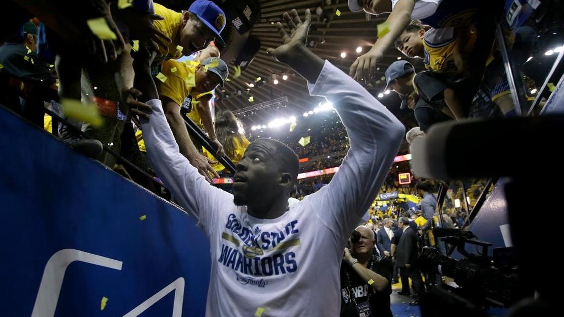 Golden State Warriors forward Draymond Green greets fans after the Warriors beat the Cleveland Cavaliers in Game 2 of basketball’s NBA Finals in Oakland, Calif., on Sunday, June 5, 2016. The Warriors won 110-77.