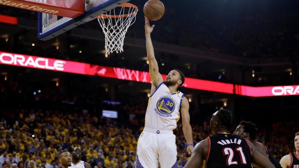 Despite a rough shooting night, Stephen Curry, center, helped the Golden State Warriors cruise past the Portland Trail Blazers on Wednesday in Oakland. Curry scored a game-high 19 points but shot just 6 of 18. Golden State leads the series 2-0.