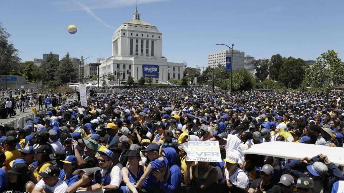 People fill a plaza at the Henry J. Kaiser Convention Center to watch the Golden State Warriors’ NBA championship rally Thursday, June 15, 2017, in Oakland, Calif. Oakland is celebrating its second championship in the past three years.