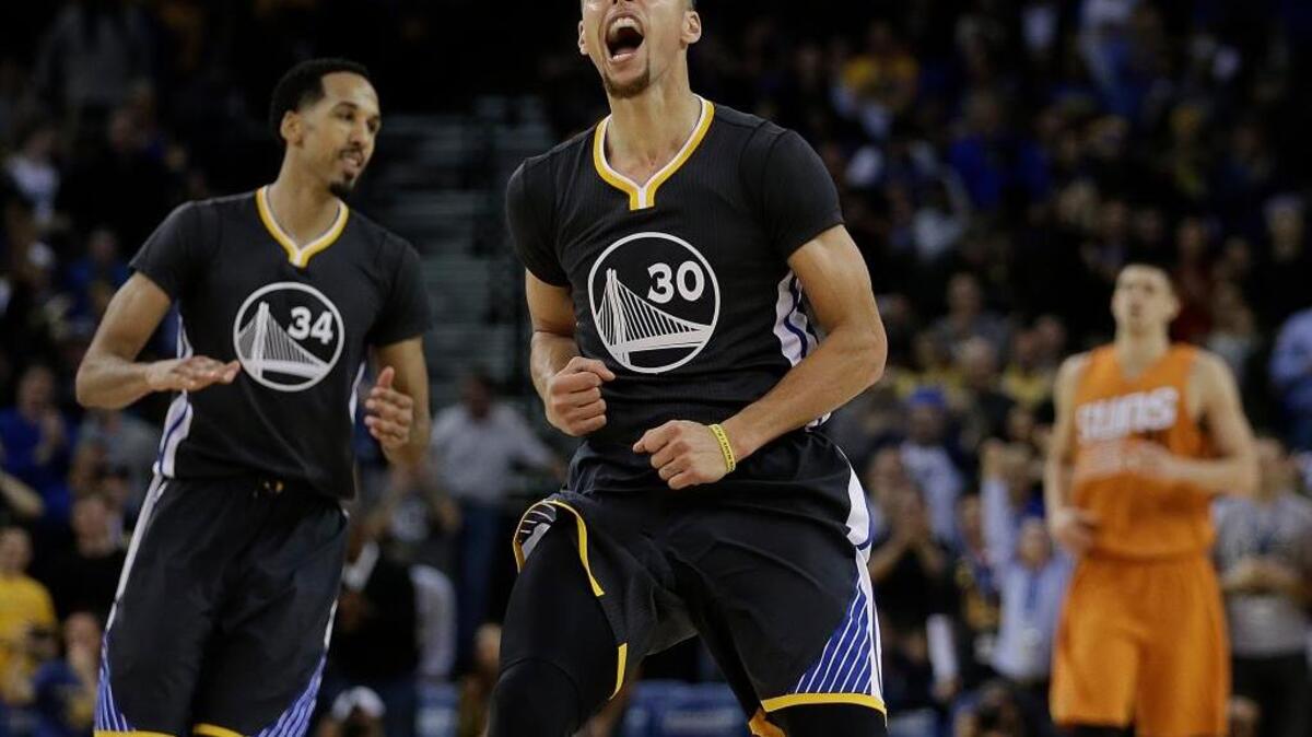 The Golden State Warriors’ Stephen Curry (30) celebrates a score in the final seconds of his team’s NBA basketball game against the against the Phoenix Suns on Saturday, March 12, 2016, in Oakland. Curry scored 15 of his game-high 35 points in the fourth quarter.