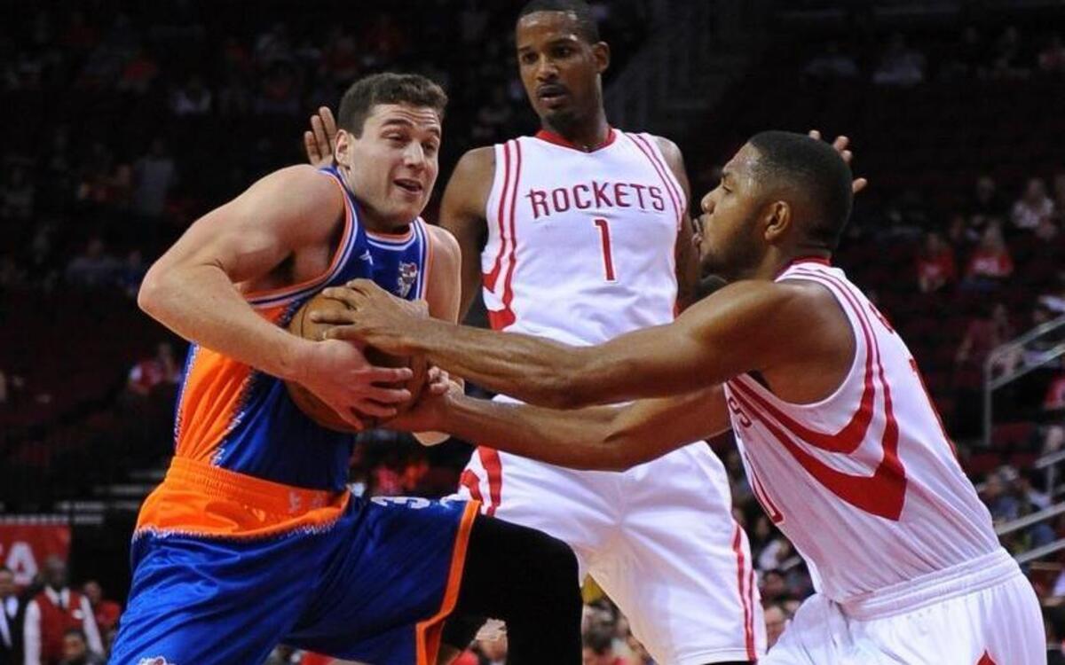 Shanghai Sharks Jimmer Fredette, left, is defended by the Houston Rockets guard Eric Gordon, right, during an NBA basketball exhibition game Sunday, Oct. 2, 2016, in Houston.