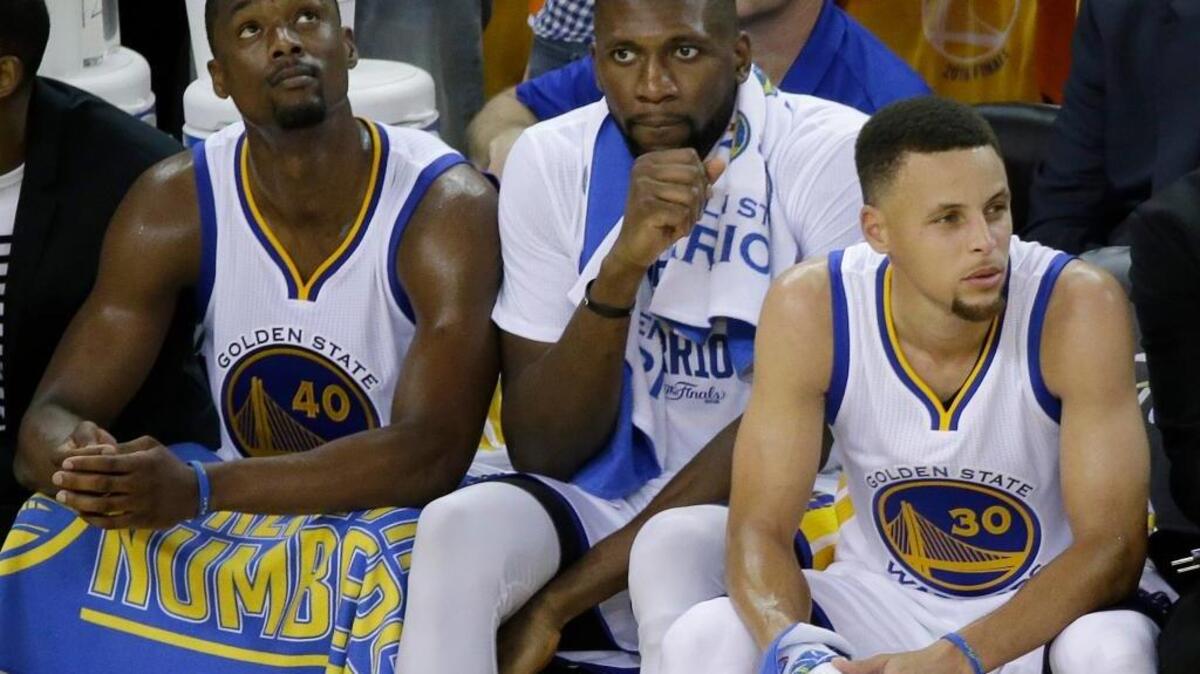 Golden State Warriors forward Harrison Barnes, from left, center Festus Ezeli and guard Stephen Curry sit on the bench during the second half of Game 5 of basketball’s NBA Finals against the Cleveland Cavaliers in Oakland, Calif., Monday, June 13, 2016. The Cavaliers won 112-97. The Warriors lead the series 3-2. Game 6 is Thursday in Cleveland.