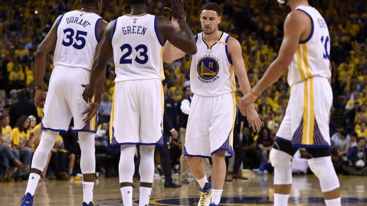 The Golden State Warriors’ All-Stars – from left, Kevin Durant, Draymond Green, Klay Thompson and Stephen Curry – celebrate during Game 1 of the Western Conference semifinals against the Utah Jazz on Tuesday in Oakland. The Warriors won 106-94.