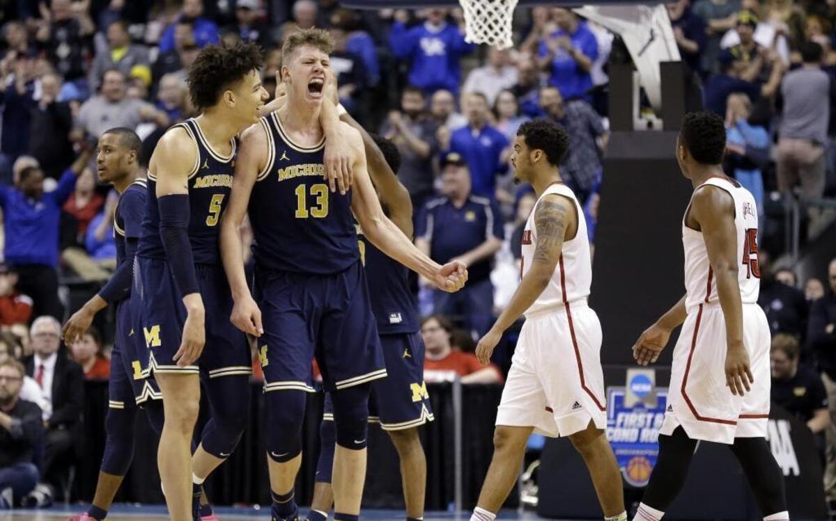 Michigan forwards D.J. Wilson, left, and Moritz Wagner celebrate during the men’s NCAA college basketball tournament in March. Wilson, drafted by the Milwaukee Bucks, continues to wear his signature shorter shorts in the NBA Summer League.