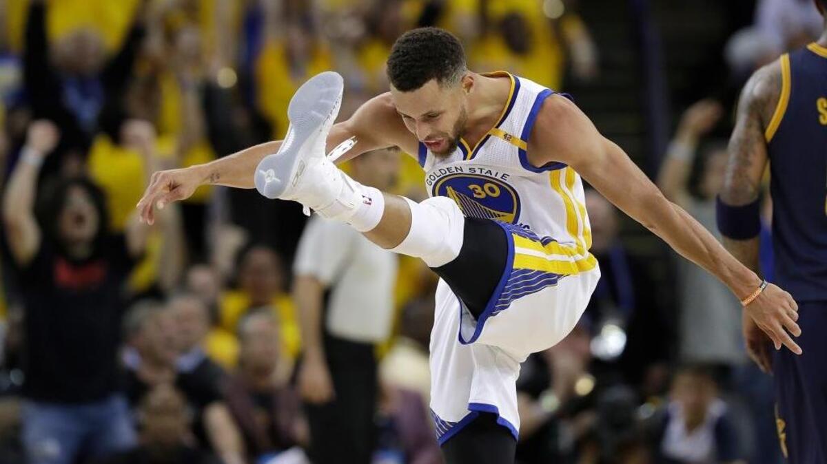 Golden State Warriors guard Stephen Curry reacts after scoring against the Cleveland Cavaliers during the second half of Game 1 of basketball's NBA Finals in Oakland, Calif., Thursday, June 1, 2017.
