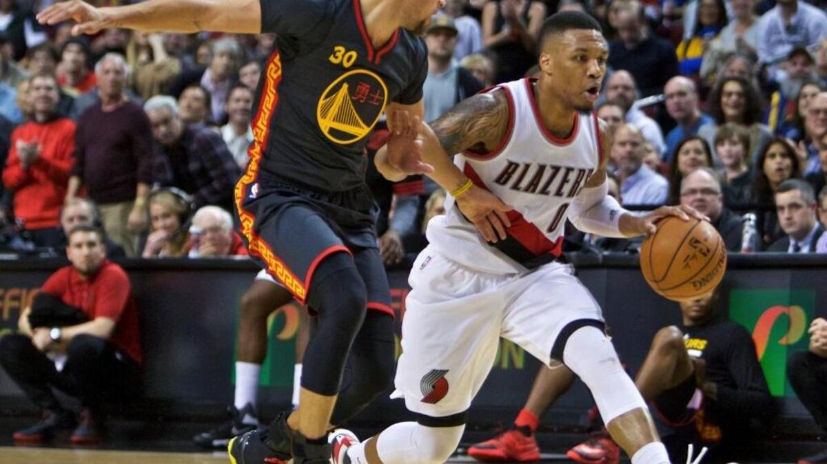 Portland’s Damian Lillard tries to move past the Warriors’ Stephen Curry during the second half in Portland, Ore., Friday, Feb. 19, 2016.