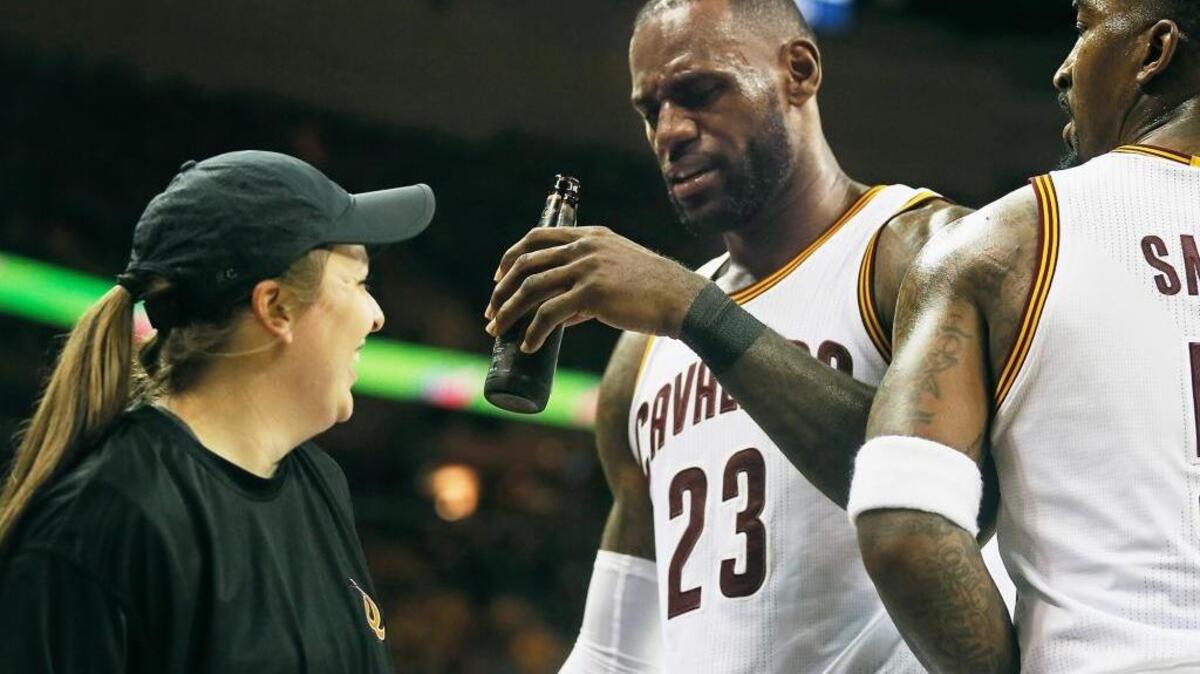 Cleveland Cavaliers forward LeBron James jokingly acts like he’s going to drink a fan’s beer during Game 1 of the Eastern Conference semifinals Monday in Cleveland. The Cavaliers beat the Toronto Raptors 116-105.