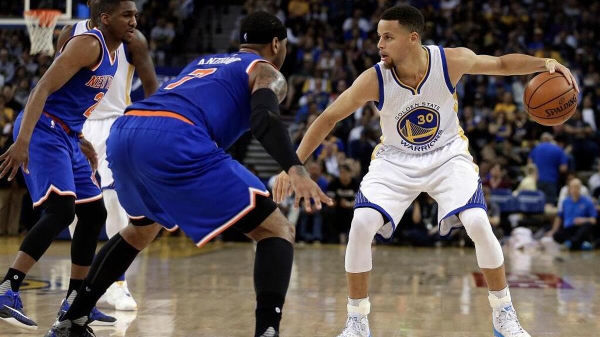 The Warriors’ Stephen Curry, right, is defended by New York Knicks Langston Galloway, left, and Carmelo Anthony during the second half of an NBA basketball game Wednesday, March 16, 2016, in Oakland.