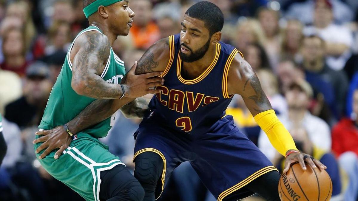 Cleveland Cavaliers guard Kyrie Irving, right, tries to get past Boston Celtics guard Isaiah Thomas on Nov. 3, 2016, in Cleveland. The two All-Star point guards will swap teams in a blockbuster deal.