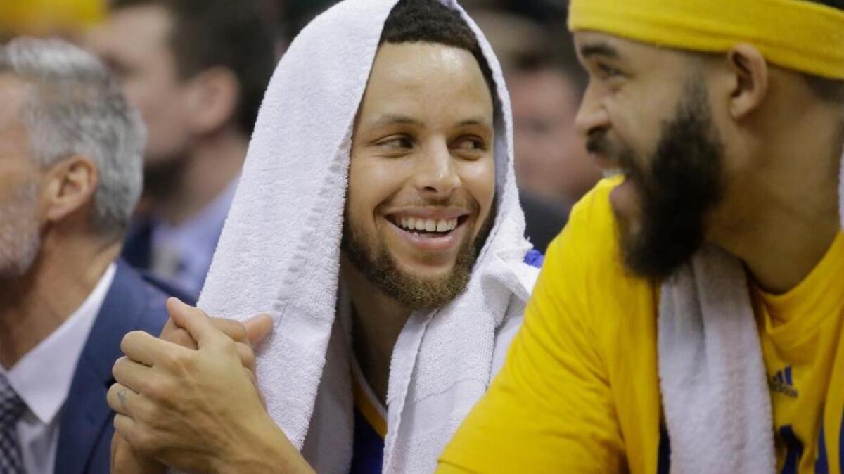 Golden State Warriors star Stephen Curry, left, lost a bet to teammate JaVale McGee on Tuesday. The penalty: Curry must wear a fanny pack to three Warriors games.