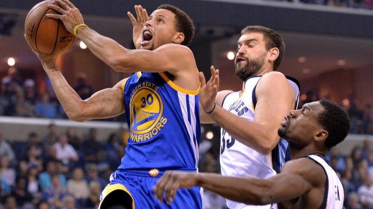In this Nov. 11, 2015, file photo, Golden State Warriors guard Stephen Curry (30) shoots against Memphis Grizzlies center Marc Gasol, center, and guard Tony Allen during an NBA basketball game in Memphis, Tenn. Curry has been named The Associated Press 2015 Male Athlete of the Year.
