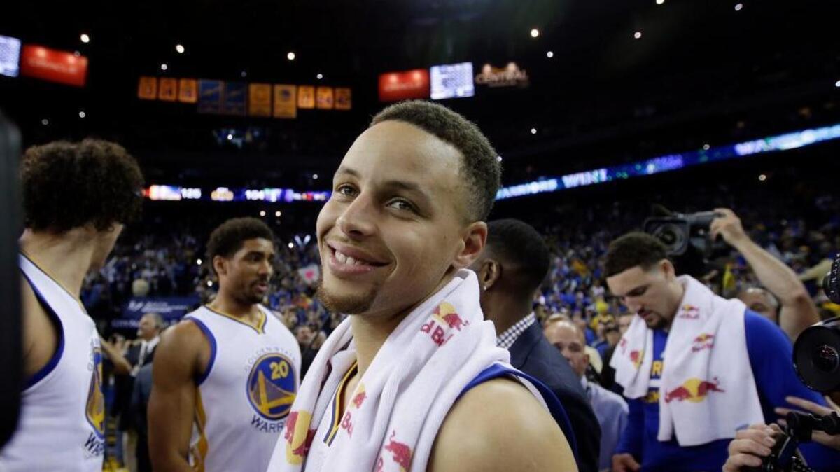 The Warriors’ Stephen Curry smiles a the end of Wednesday night’s 125-104 victory – the Warriors’ record 73rd win of the season – over the Memphis Grizzlies in Oakland.