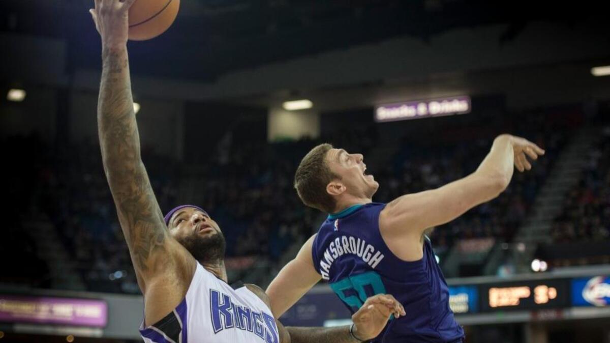 Sacramento Kings center DeMarcus Cousins (15), defended here by Charlotte Hornets forward Tyler Hansbrough (50), scores a career-high 56 points in an NBA basketball game on Monday, Jan. 25, 2016 at Sleep Train Arena in Sacramento.