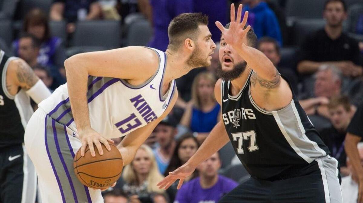 Kings center Georgios Papagiannis is defended by San Antonio Spurs forward Joffrey Lauvergne (77) in their preseason game on Oct. 2 at Golden 1 Center.