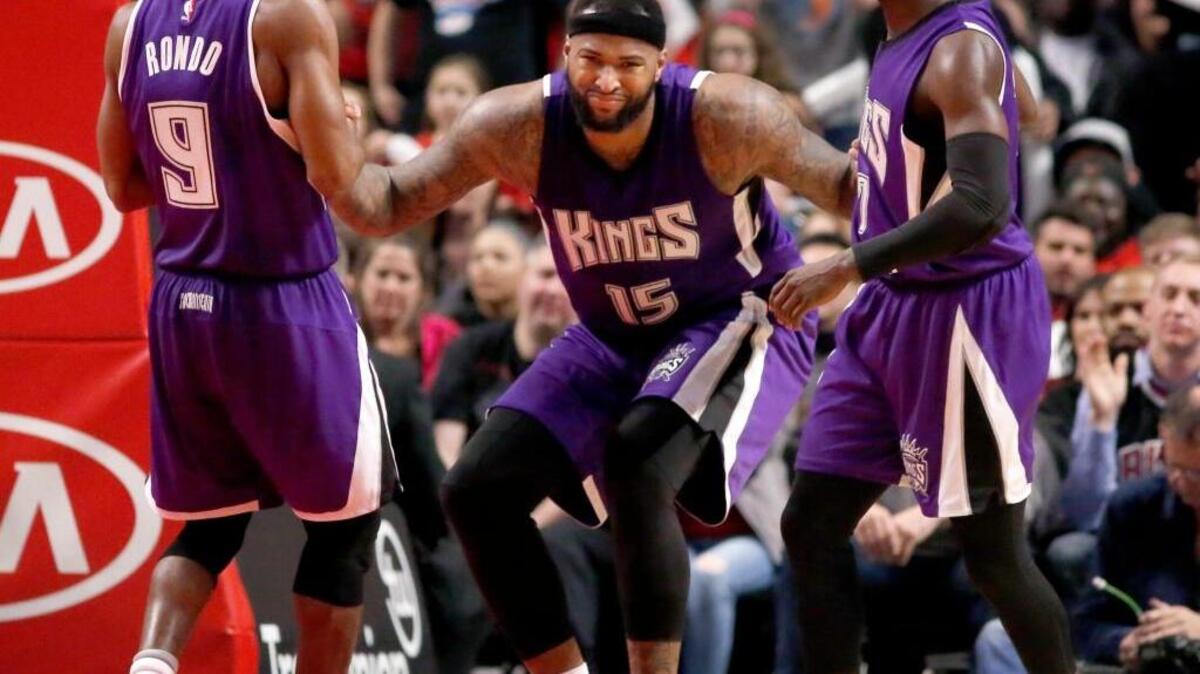 Rajon Rondo (9) and Darren Collison, right, help Sacramento Kings teammate DeMarcus Cousins off the floor during an NBA basketball game against the Chicago Bulls Monday, March 21, 2016, in Chicago. Cousins led the Kings with 19 points and 18 rebounds.
