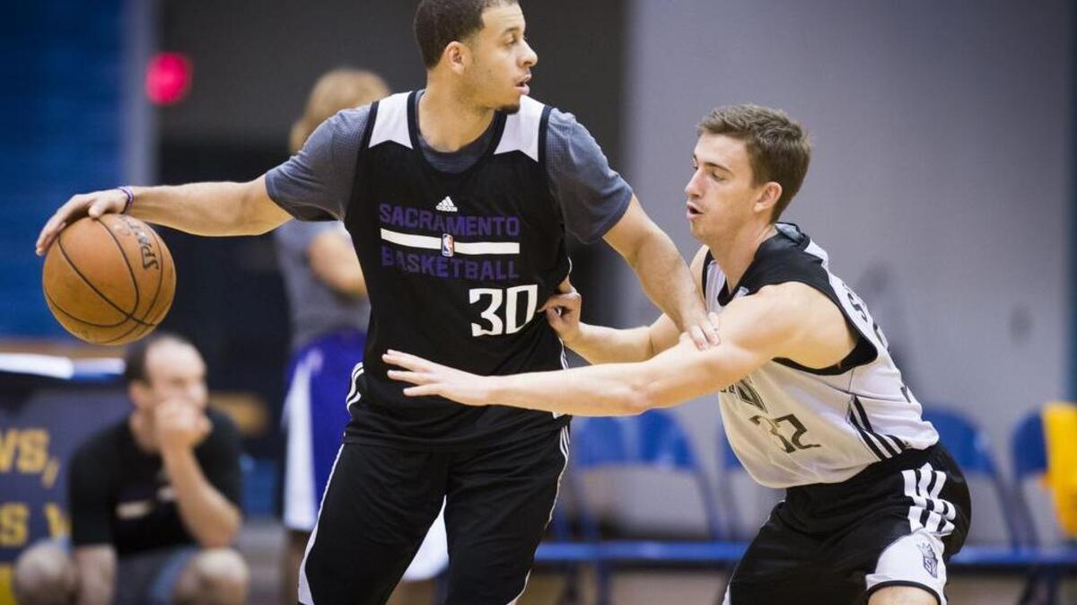 Seth Curry, (30) of the Sacramento Kings looks to make a play as he's defended by teammate David Stockton, (32) during training camp at UC San Diego's RIMAC Arena on Thursday, Oct. 1, 2015.
