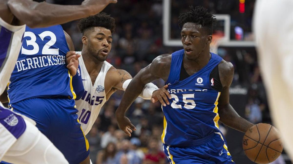 The Warriors' Kendrick Nunn is held by Kings guard Frank Mason III (10) as he drives to the basket in the fourth quarter as Sacramento hosts Golden State in the California Classic summer league at Golden 1 Center on July 3, 2018.