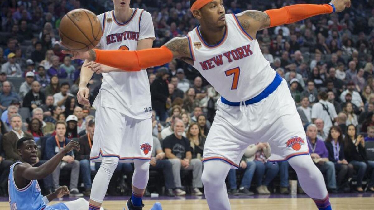 Sacramento Kings guard Darren Collison (7) falls on the court as New York Knicks forward Carmelo Anthony (7) recovers the ball during their game at Golden 1 Center in Sacramento on Friday, December 9, 2016.