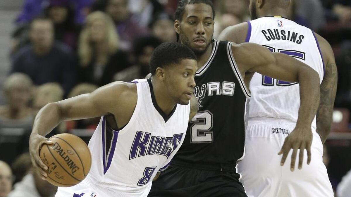 Kings forward Rudy Gay, left, drives against San Antonio forward Kawhi Leonard during the first quarter at Sleep Train Arena in Sacramento, Calif., Monday, Nov. 9, 2015.