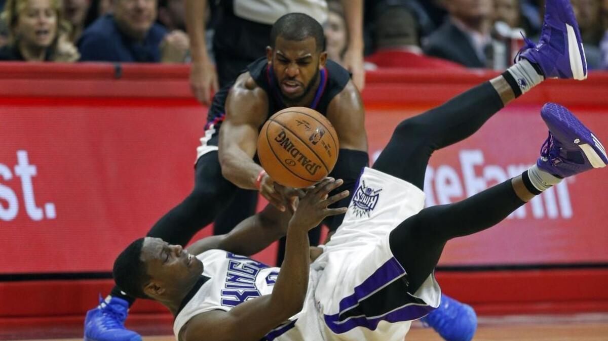 The Los Angeles Clippers’ Chris Paul, top, contests a loose ball with the Sacramento Kings’ Darren Collison in during an NBA basketball game on Saturday, Jan. 16, 2016 at Staples Center in Los Angeles.