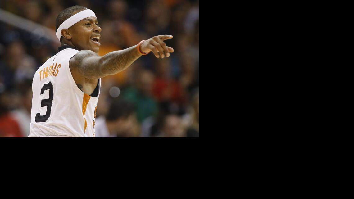 
Phoenix Suns guard Isaiah Thomas (3) points to a teammate after scoring during the first half of an NBA basketball game against the Memphis Grizzlies, Wednesday, Nov. 5, 2014, in Phoenix.
