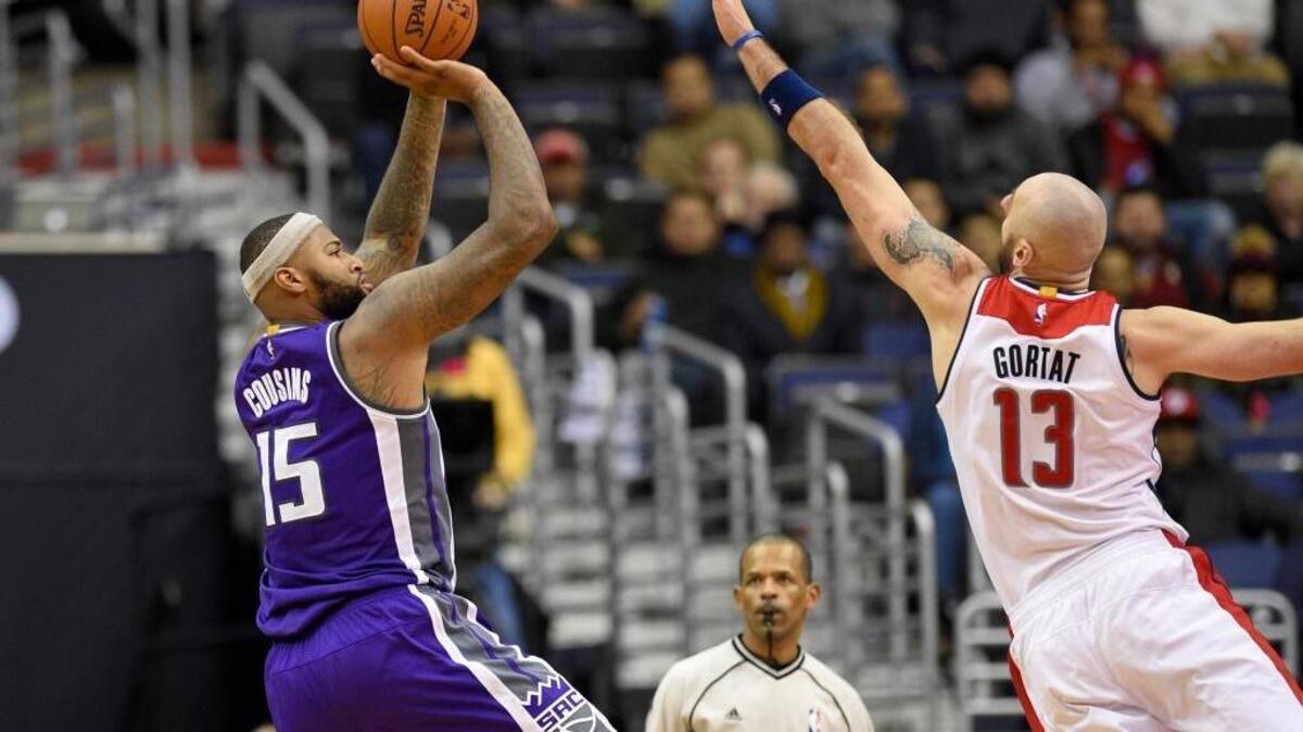 Sacramento Kings center DeMarcus Cousins (15) takes a shot against Washington Wizards center Marcin Gortat, of Poland, (13) during an NBA basketball game, Monday, Nov. 28, 2016, in Washington. The Wizards won 101-95 in overtime.