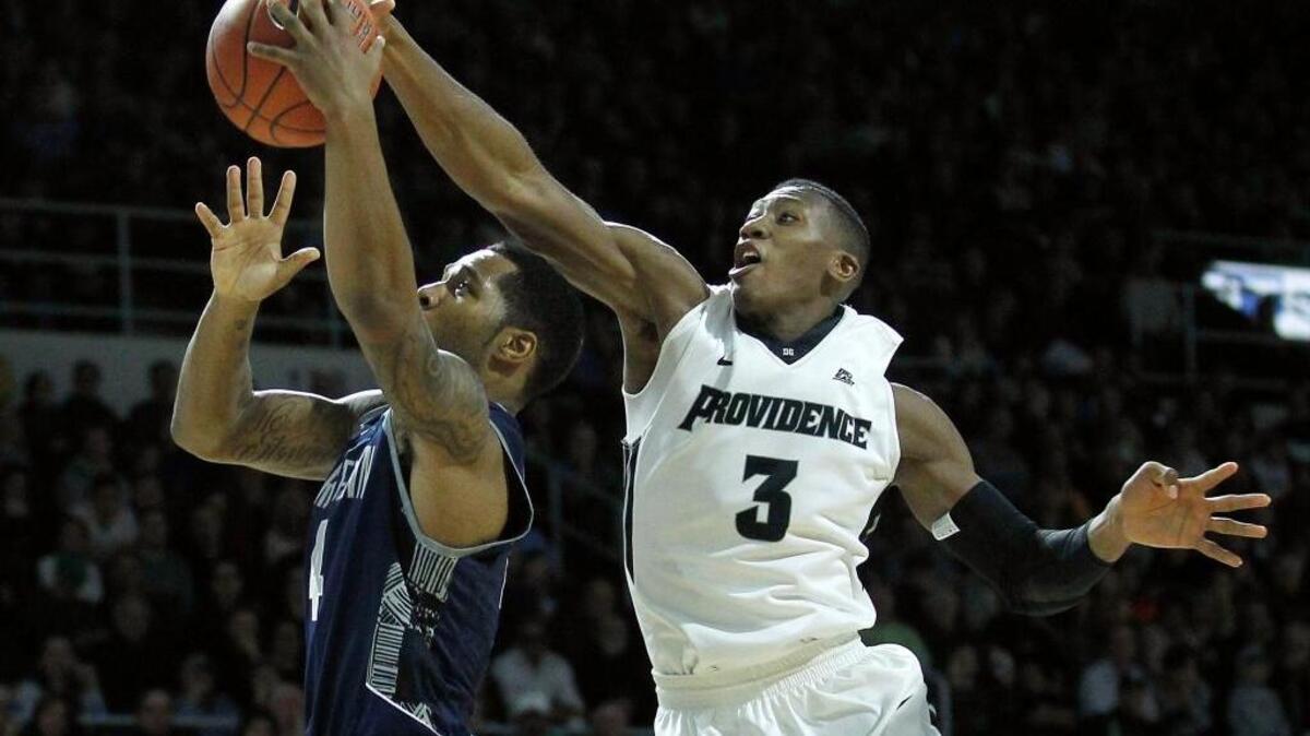 Providence guard Kris Dunn (3) blocks a shot by Georgetown guard D’Vauntes Smith-Rivera in Providence, R.I., Feb. 13, 2016.