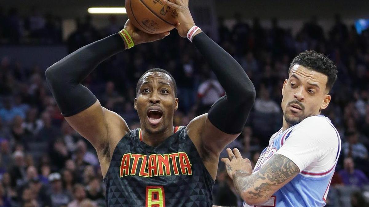 Atlanta Hawks center Dwight Howard, left, reacts after being called for a foul during the first half against the Sacramento Kings on Friday, Feb. 10, 2017, in Sacramento, Calif. At right is Kings forward Matt Barnes.
