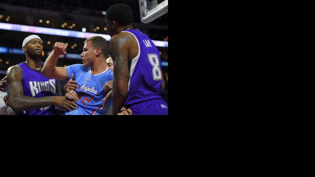 
DeMarcus Cousins, left, and Rudy Gay, right, of the Kings play peacemakers after Blake Griffin, center, of the Clippers was fouled hard by Sacramento’s Ben McLemore.
