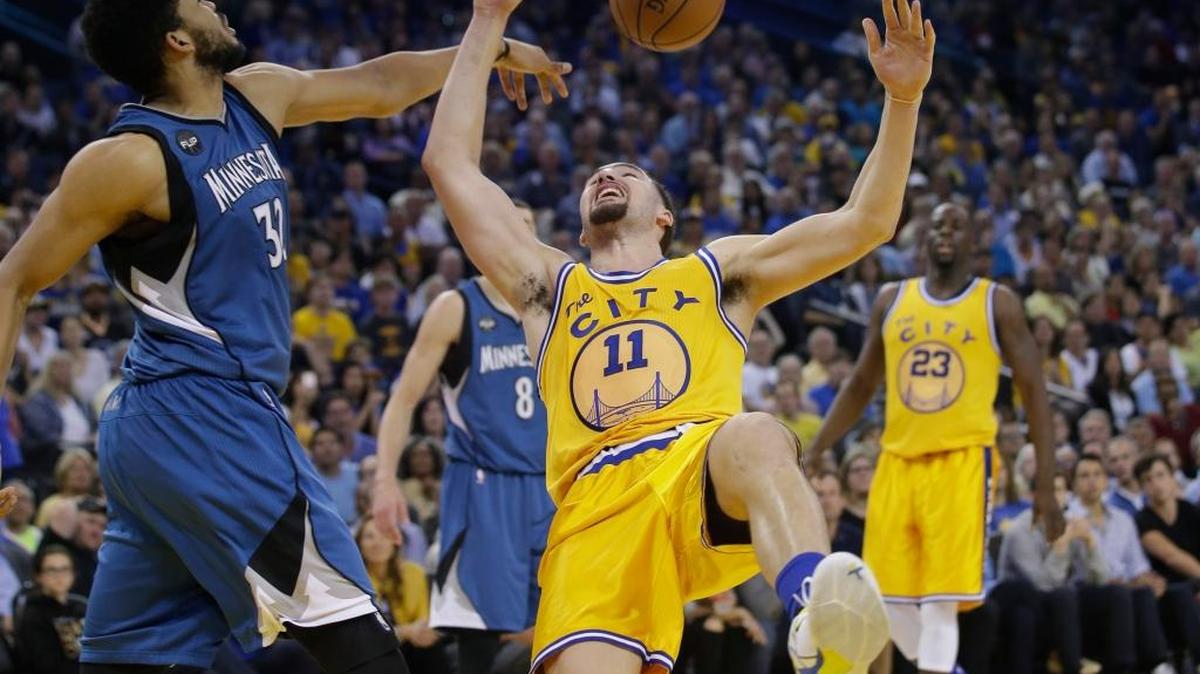 The Golden State Warriors’ Klay Thompson (11) has his shot blocked by the Minnesota Timberwolves’ Karl-Anthony Towns (32) during an NBA basketball game Tuesday, April 5, 2016, in Oakland. Minnesota won 124-117 in overtime.