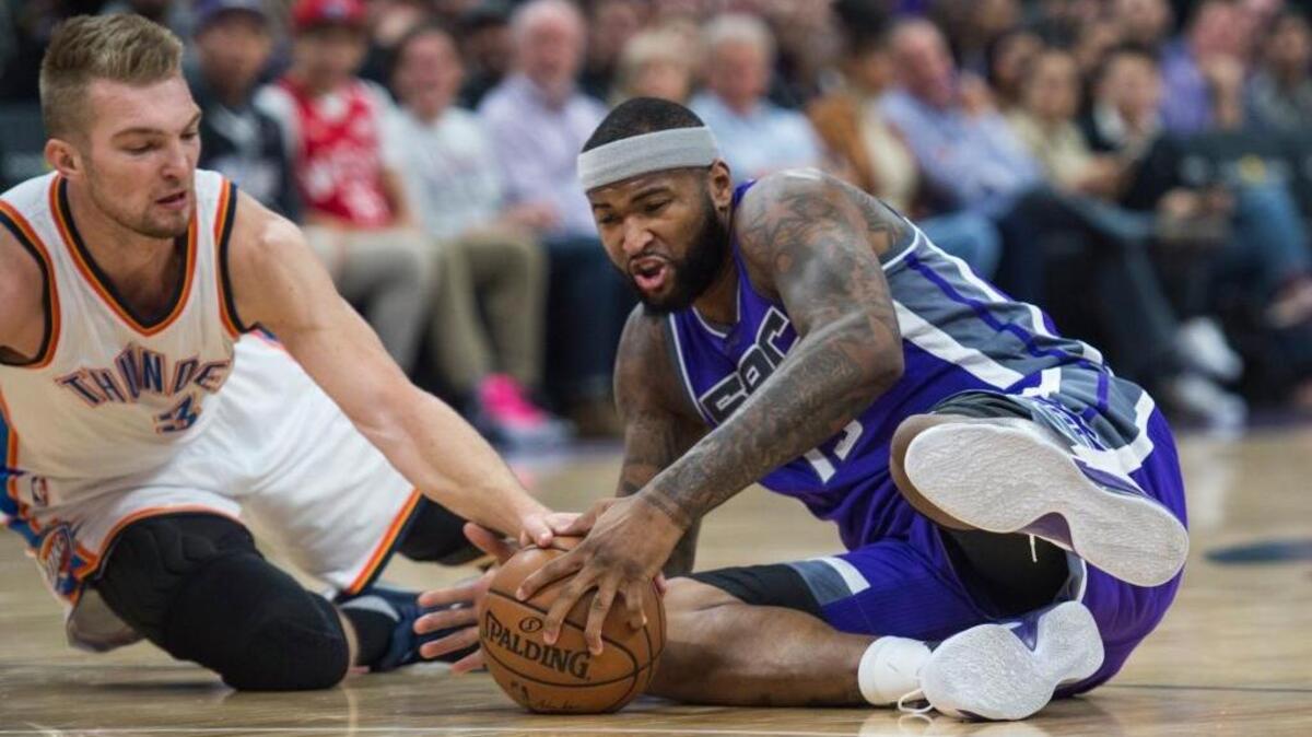 Kings center DeMarcus Cousins battles for the ball against Oklahoma City Thunder forward Domantas Sabonis during the first quarter Wednesday night at Golden 1 Center in Sacramento. Cousins had 36 points and 13 rebounds in the Kings’ 116-101 victory.