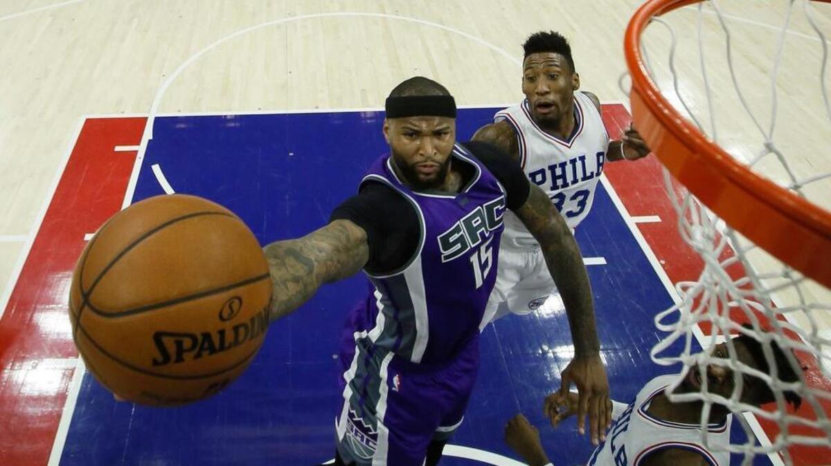 DeMarcus Cousins drives past Philadelphia’s Robert Covington on Monday. Cousins was named the Western Conference Player of the Week after averaging 27.8 points and 14.5 rebounds in leading the Kings to a 3-1 record.