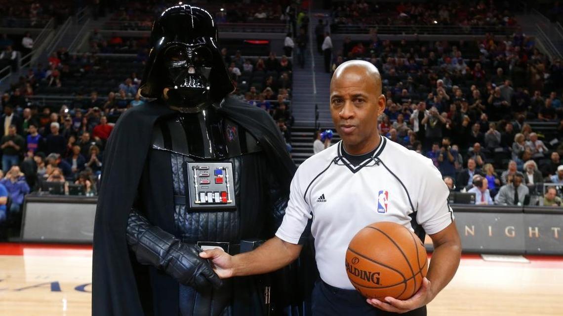 Darth Vader from “Star Wars” shakes hands with NBA referee Derrick Stafford at a game in 2015. The league’s online store is selling tops which celebrate the Kings and the film franchise.