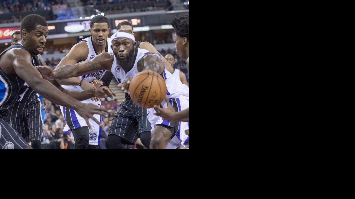 
Kings forward Rudy Gay (8), center, and Kings forward Reggie Evans (30) scramble for a loose ball during the game between the Sacramento Kings and the Orlando Magic at Sleep Train Arena in Sacramento on Friday, December 5, 2014.
