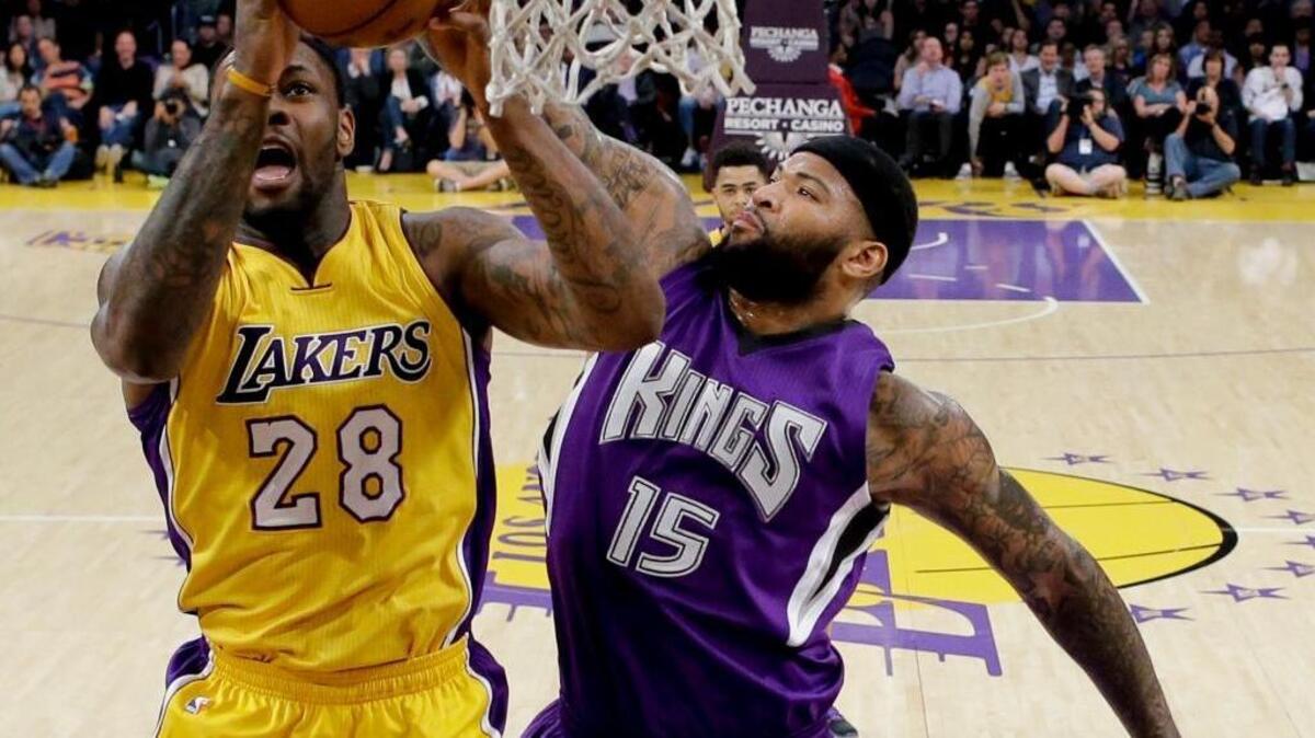 Kings center DeMarcus Cousins blocks a shot by Los Angeles Lakers center Tarik Black during the first half of an NBA basketball game in Los Angeles, Tuesday, March 15, 2016.