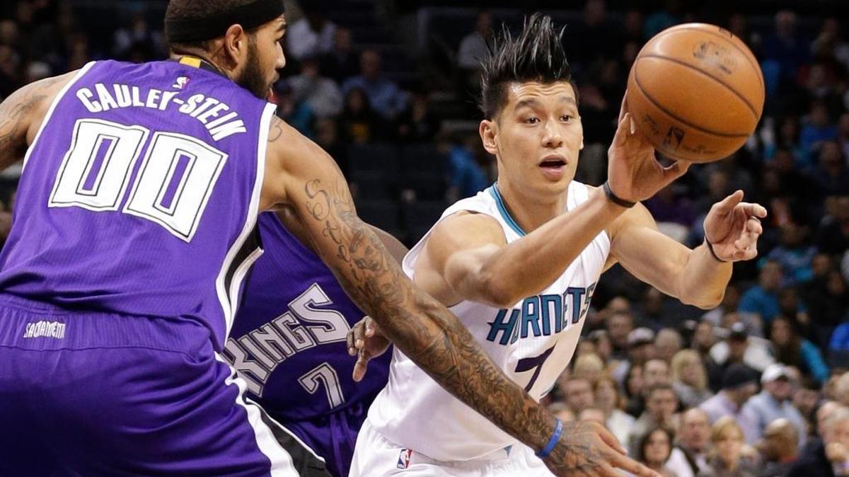 Charlotte’s Jeremy Lin, right, passes the ball as Willie Cauley-Stein of Sacramento defends during an NBA basketball game in Charlotte, N.C., Monday, Nov. 23, 2015. Lin finished with 14 points off the bench for the Hornets. Cauley-Stein was scoreless in eight minutes as a Kings starter.