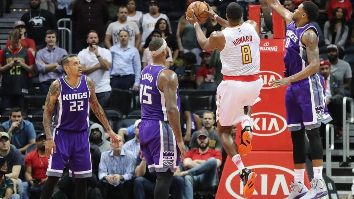The Atlanta Hawks’ Dwight Howard drives to the basket as the Sacramento Kings’ Rudy Gay defends. Kings Matt Barnes, left, and DeMarcus Cousins look on during an NBA basketball game, Monday, Oct. 31, 2016 in Atlanta.