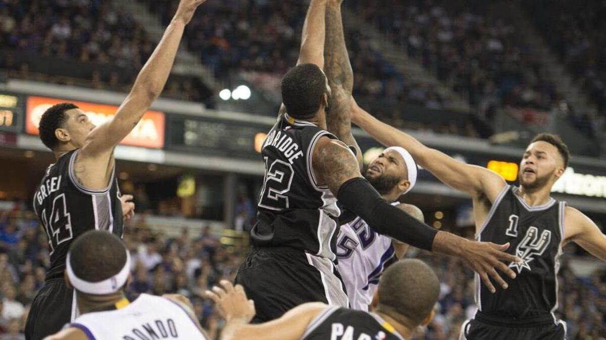 Sacramento Kings center DeMarcus Cousins draws a crowd of San Antonio Spurs defenders during an NBA basketball game on Wednesday, Feb. 22, 2016 at Sleep Train Arena in Sacramento. Cousins averages nearly seven more points a game at home than on the road. That isn’t good news considering the Kings have three road games this week.