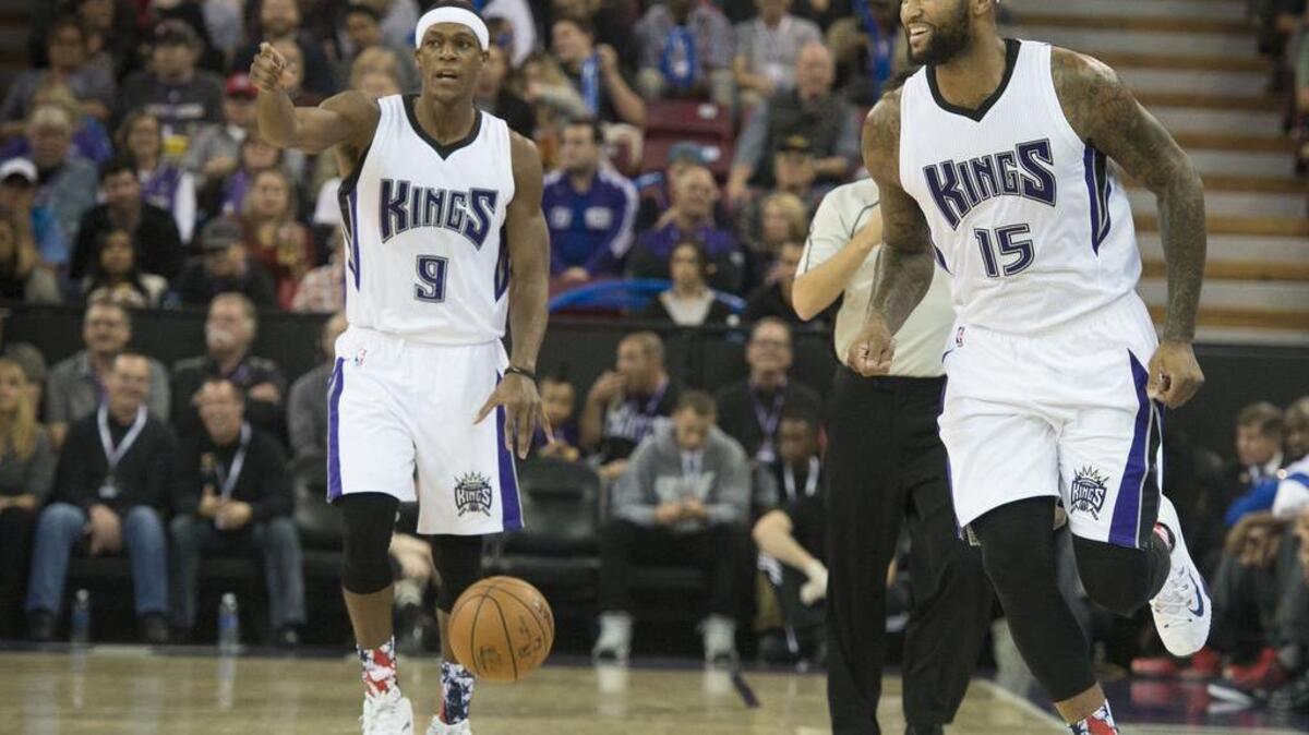Kings guard Rajon Rondo (9) calls a play as a smiling Kings forward DeMarcus Cousins (15) goes down the court against the Detroit Pistons on Wednesday, Nov. 11, 2015 at Sleep Train Arena in Sacramento.