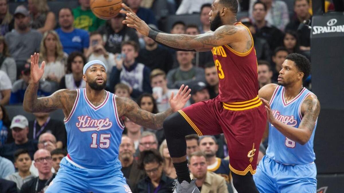 The Kings DeMarcus Cousins (15) and Rudy Gay (8) defend the Cleveland Cavaliers’ LeBron James during their game at Golden 1 Center on Friday night.