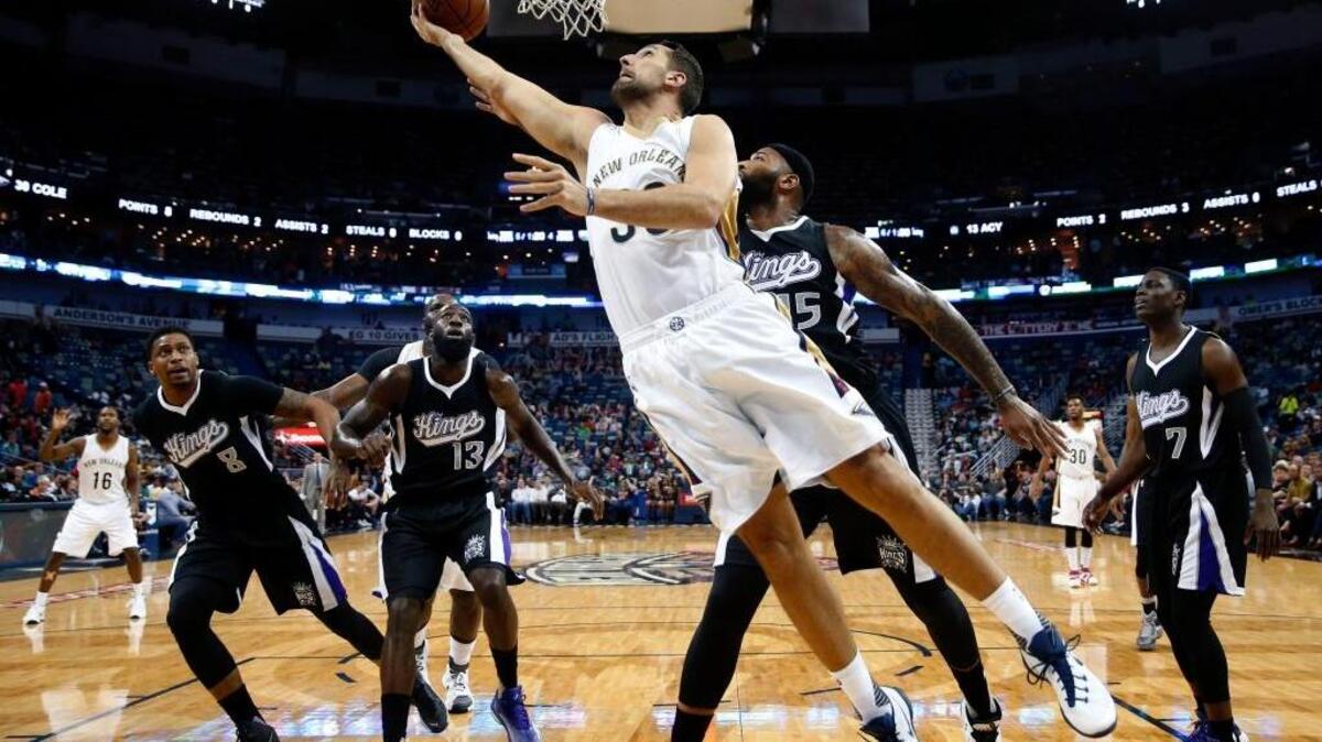 New Orleans Pelicans forward Ryan Anderson (33) goes to the basket against Sacramento Kings forward Rudy Gay (8), center DeMarcus Cousins (13), and forward Quincy Acy (13) during an NBA basketball game in New Orleans, Monday, March 7, 2016. Anderson finished with 19 points.