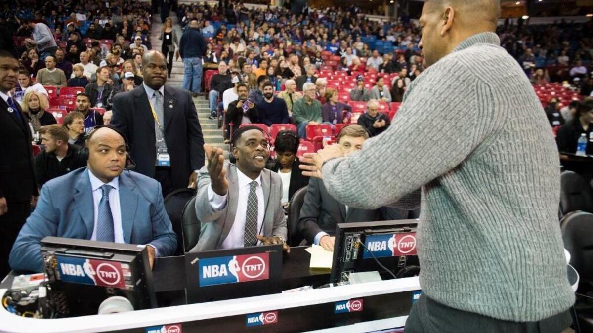 Former Kings player and TNT announcer Chris Webber talks with mayor Kevin Johnson during the Kings game against the New York Knicks at Sleep Train Arena in Sacramento on Thursday, Dec. 10, 2015.