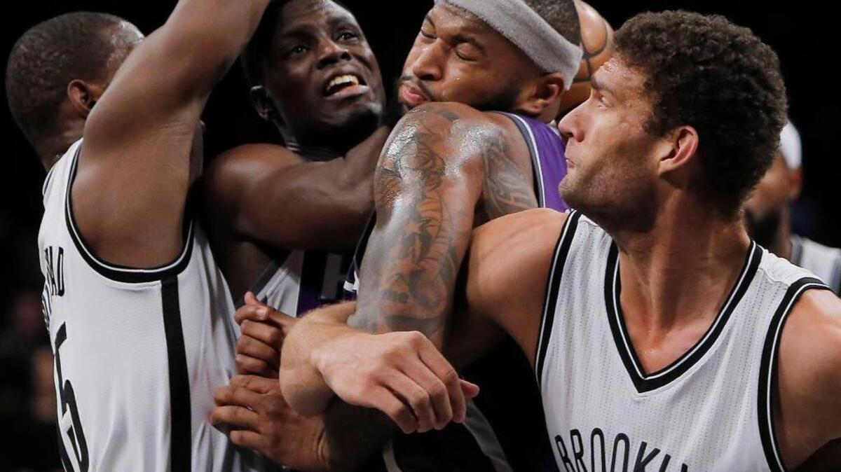 Sacramento Kings guard Darren Collison, second left, drives to the basket in between Brooklyn Nets center Brook Lopez, right, Nets guard Isaiah Whitehead, left, and Kings center DeMarcus Cousins, second right, during an NBA basketball game in New York on Sunday, Nov. 27, 2016.