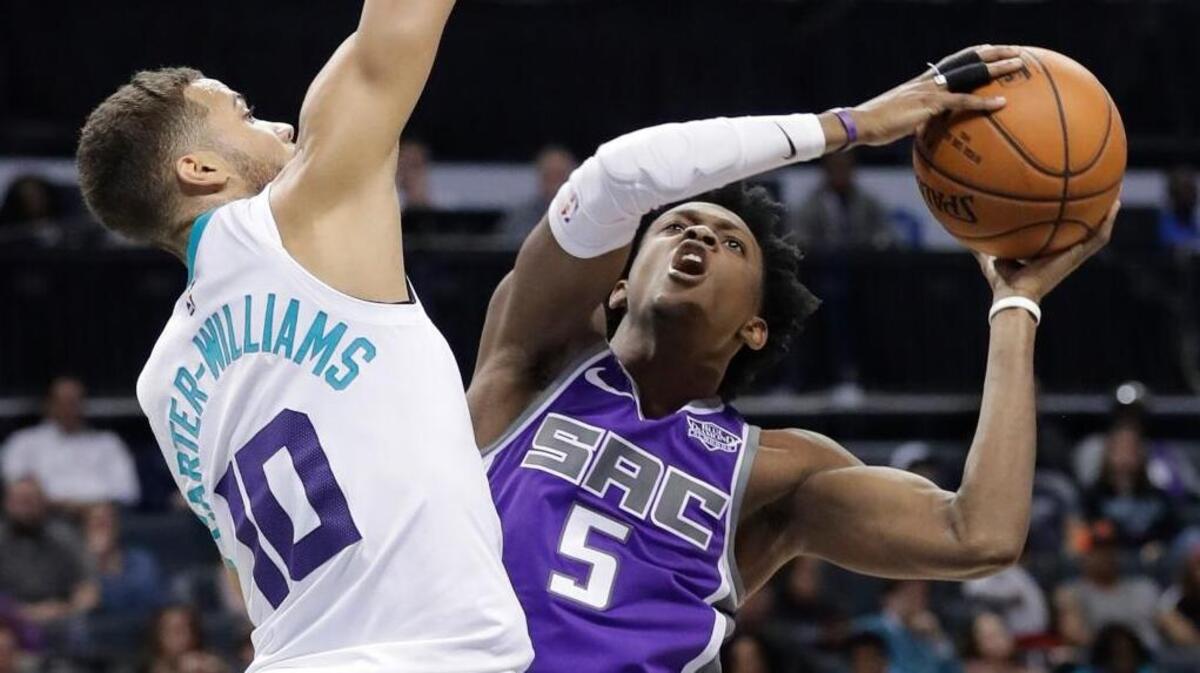 Kings guard De’Aaron Fox shoots against Charlotte Hornets guard Michael Carter-Williams on Monday in Charlotte, N.C.