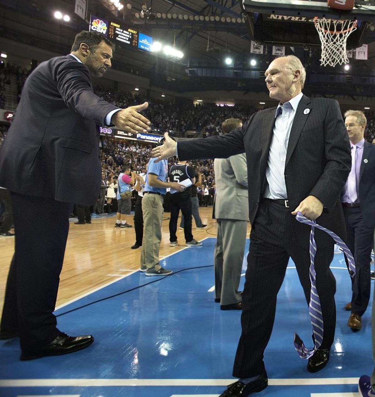 George Karl, right, gets a handshake from Vlade Divac as he leaves the floor at Sleep Train Arena for the final time as the Kings’ coach on April 9, 2016.