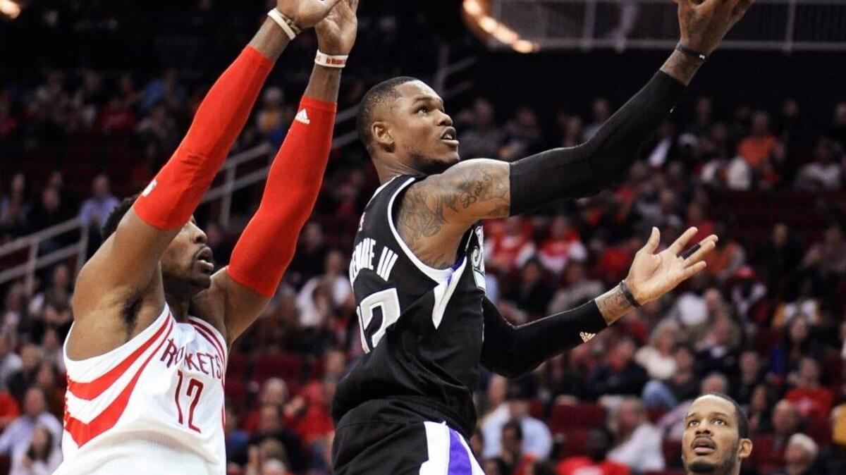 Sacramento Kings’ Ben McLemore, center, goes to the basket between Houston Rockets Dwight Howard (12) and Trevor Ariza (1) during the first half Saturday, Dec. 5, 2015, in Houston.