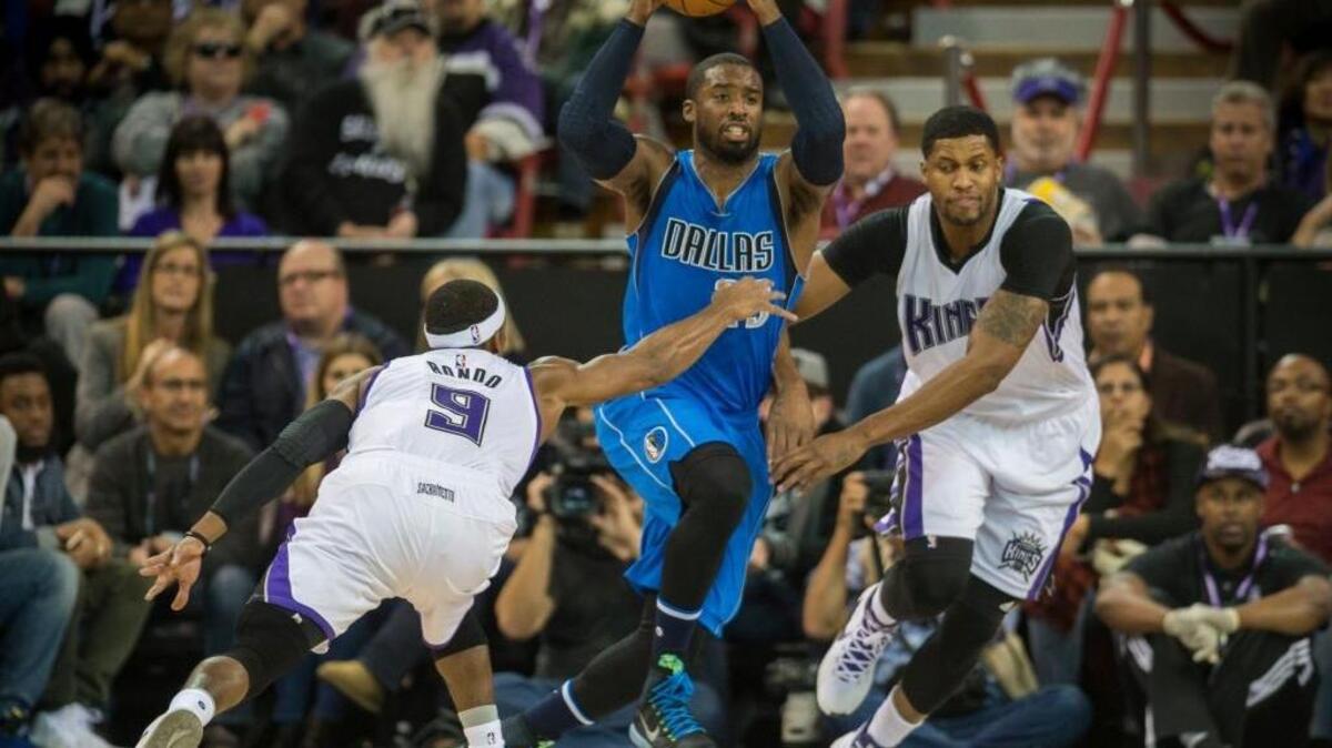 Dallas Mavericks guard Wesley Matthews (23) is guarded by the Sacramento Kings guard Rajon Rondo (9) and forward Rudy Gay (8) during an NBA basketball game on Monday, Nov. 30, 2015 at Sleep Train Arena in Sacramento. The Kings are allowing a league-high 29.2 three-point attempts per game this season.